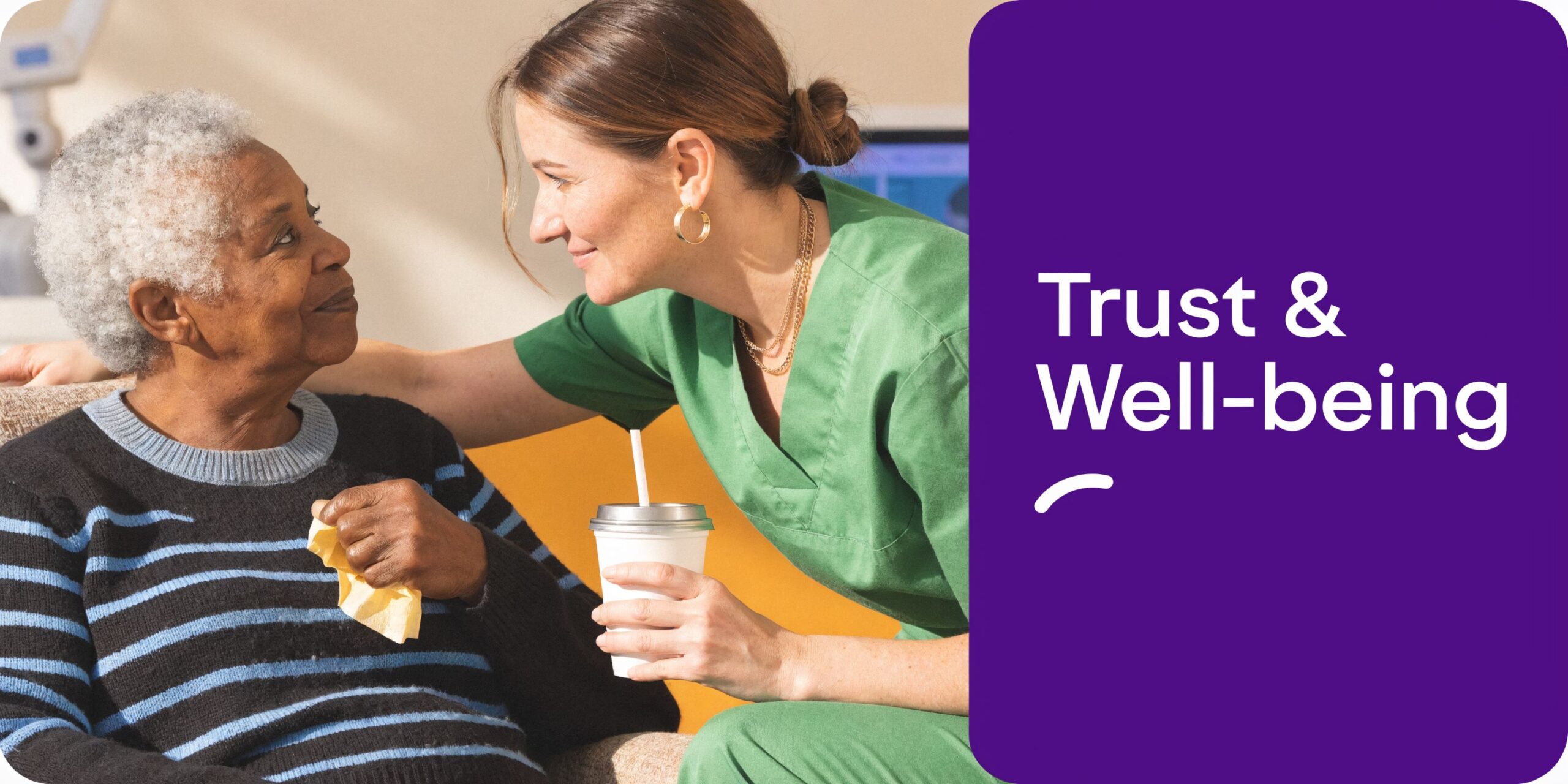 A compassionate caregiver in green scrubs providing support and care to an elderly woman in a clinical setting.