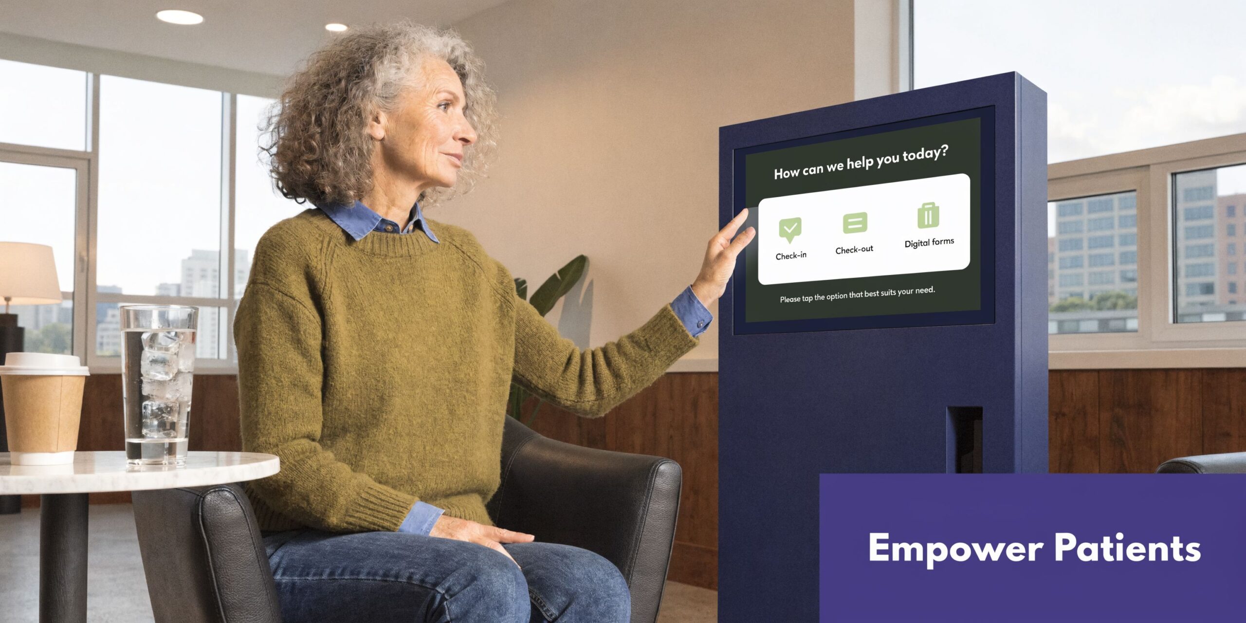 A woman with grey hair interacting with a digital patient check-in kiosk in a medical office lobby.