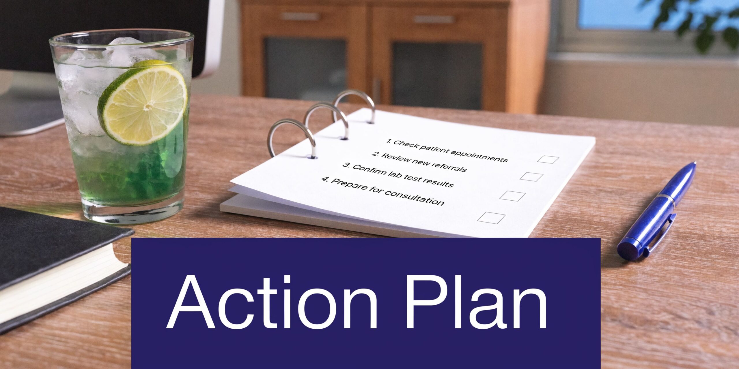 A close-up of a desk featuring a checklist labeled Action Plan and a refreshing green drink.