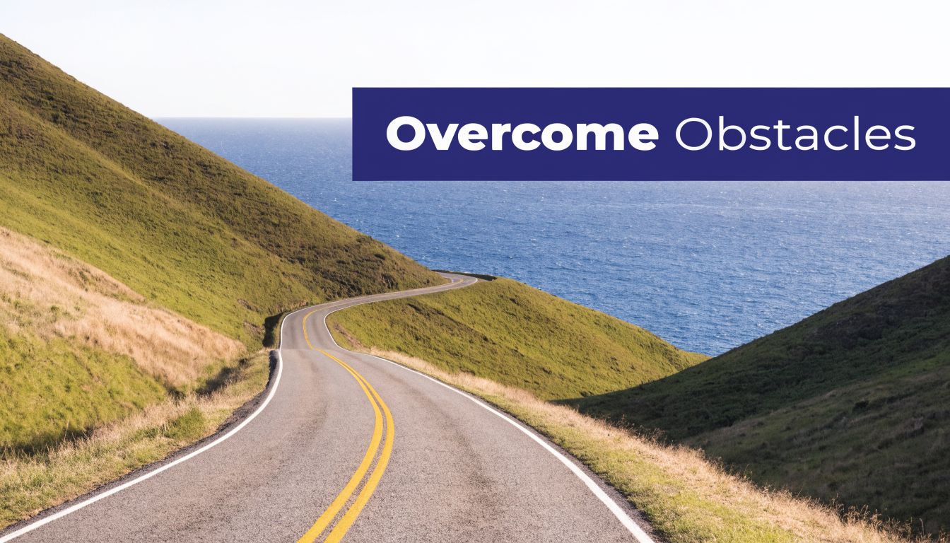 A winding asphalt road leading through scenic green hills towards a calm, deep blue ocean view.