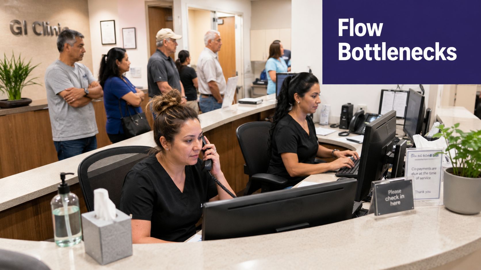 Front desk staff working at a medical clinic while patients wait in a line behind them.
