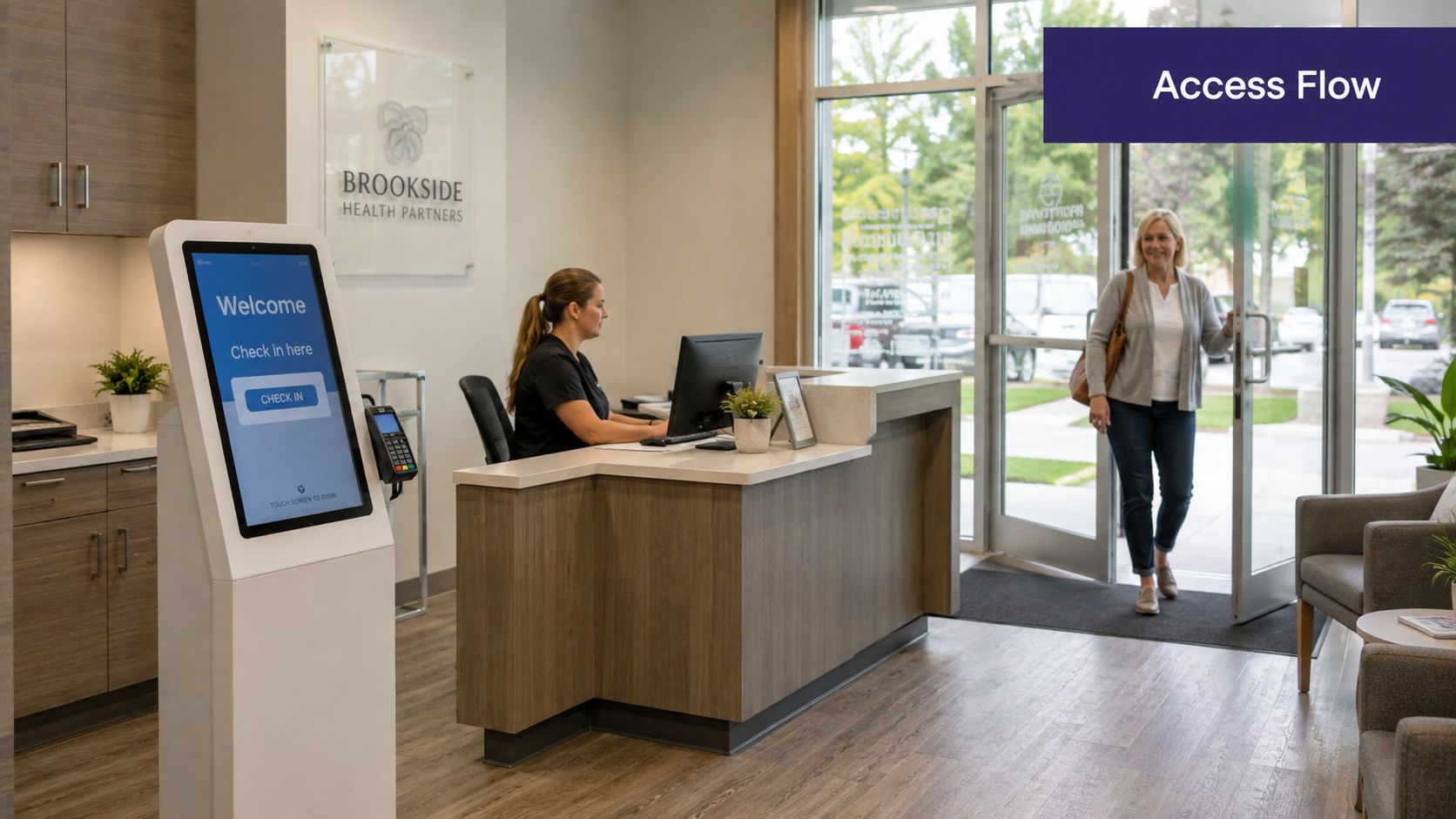 A woman entering the reception area of a medical practice past a digital check-in kiosk and desk.